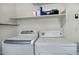 Laundry room with washer, dryer, and overhead shelving at 18048 W Spencer Dr, Surprise, AZ 85374