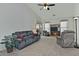 Living room with gray couches, a recliner, and a built-in entertainment center at 18048 W Spencer Dr, Surprise, AZ 85374