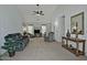 Living room with gray couches, a recliner, and a built-in entertainment center at 18048 W Spencer Dr, Surprise, AZ 85374