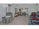 Living room with gray couch, recliner, and view of dining area at 18048 W Spencer Dr, Surprise, AZ 85374
