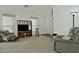 Living room with a gray recliner, rocking chair and built-in shelving at 18048 W Spencer Dr, Surprise, AZ 85374