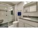 Clean bathroom with a walk-in shower and granite countertop at 18435 N 125Th Ave, Sun City West, AZ 85375