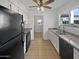Clean kitchen with black appliances, double sink and access to backyard at 3007 W Redfield Rd, Phoenix, AZ 85053