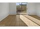Empty spare bedroom with tile flooring and sliding glass door to backyard at 3007 W Redfield Rd, Phoenix, AZ 85053