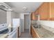 Galley kitchen with granite countertops and white appliances at 4223 S 47Th Pl, Phoenix, AZ 85040