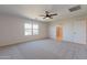 Main bedroom with carpet, large window, and ensuite bath at 688 W Carlsbad Dr, San Tan Valley, AZ 85140