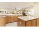 Spacious kitchen with wood cabinets, stainless steel appliances and island at 7782 E Wildcat Dr, Gold Canyon, AZ 85118