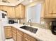 Clean kitchen with light wood cabinets, granite counters, and a large sink at 795 S Cinnabar Dr, Apache Junction, AZ 85119