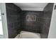 Bathroom with shower and tub combo, dark tile, and mosaic accents at 9029 W Flower St, Phoenix, AZ 85037