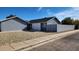 Gray exterior home with a block wall and a gravel front yard at 9029 W Flower St, Phoenix, AZ 85037