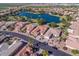 Aerial view of houses and a lake with fountain at 9521 E Rocky Lake Dr, Sun Lakes, AZ 85248