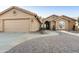 Tan stucco house with a tile roof, desert landscaping, and a stone walkway at 9521 E Rocky Lake Dr, Sun Lakes, AZ 85248