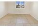 Simple bedroom with tile flooring and large window at 1013 W Angela Dr, Phoenix, AZ 85023