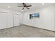 Bright bedroom with wood-look floors and mirrored closet doors at 102 W Maryland Ave # F1, Phoenix, AZ 85013