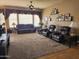 Living room featuring brown leather furniture, hardwood and carpeted floors, and large windows at 1073 E Buena Vista Dr, Chandler, AZ 85249