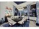 Formal dining room features a dark wood table, white chairs, and stylish blue curtains at 10891 E Via Dona Rd, Scottsdale, AZ 85262