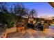 Comfortable patio seating area with fireplace and built-in bar at 10891 E Via Dona Rd, Scottsdale, AZ 85262