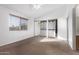 Bright bedroom with large window, ceiling fan, and mirrored closet doors at 12445 N 21St Ave # 28, Phoenix, AZ 85029