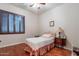 Cozy bedroom with hardwood floors and window shutters at 12889 N 145Th Way, Scottsdale, AZ 85259