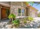 Charming home exterior with stone facade and well-manicured landscaping at 12889 N 145Th Way, Scottsdale, AZ 85259