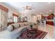 Open living area with a curved sofa and views into kitchen and dining area at 12889 N 145Th Way, Scottsdale, AZ 85259