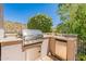 Outdoor kitchen with built-in grill and refrigerator at 12889 N 145Th Way, Scottsdale, AZ 85259