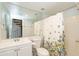 Clean bathroom with white vanity, shower/tub combo, and floral shower curtain at 1425 E Desert Cove Ave # 32, Phoenix, AZ 85020