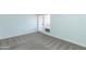 Bright bedroom with gray carpeting and doors leading to a patio at 1425 E Desert Cove Ave # 32, Phoenix, AZ 85020