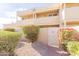 Building exterior with a light beige finish, landscaping, and a white gate at 1425 E Desert Cove Ave # 32, Phoenix, AZ 85020