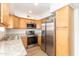 Modern kitchen with stainless steel appliances and light wood cabinets at 1425 E Desert Cove Ave # 32, Phoenix, AZ 85020
