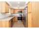 Modern kitchen with stainless steel appliances and light wood cabinets at 1425 E Desert Cove Ave # 32, Phoenix, AZ 85020