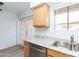 Bright kitchen features stainless steel appliances and wood cabinets at 1425 E Desert Cove Ave # 32, Phoenix, AZ 85020