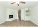 Bright living room featuring a fireplace, built-in shelving, and wood-look floors at 1425 E Desert Cove Ave # 32, Phoenix, AZ 85020