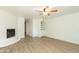 Bright living room featuring a fireplace, built-in shelving, and wood-look floors at 1425 E Desert Cove Ave # 32, Phoenix, AZ 85020