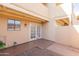 Private patio with double doors and a small, gravel yard at 1425 E Desert Cove Ave # 32, Phoenix, AZ 85020