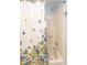 Clean shower with floral shower curtain and grab bars for safety at 1425 E Desert Cove Ave # 32, Phoenix, AZ 85020