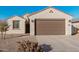 Front view of the house with a two-car garage at 1650 E Kingman Pl, Casa Grande, AZ 85122