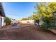 Backyard with dirt, some plants, and a small patio at 1702 W Indian School Rd, Phoenix, AZ 85015