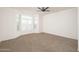 Spacious bedroom with neutral carpeting and large window at 22701 N Dusty Trail Blvd, Sun City West, AZ 85375