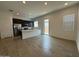 Open kitchen with island, stainless steel appliances, and tile floors at 22948 E Twin Acres Dr, Queen Creek, AZ 85142