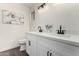 Bathroom with double vanity, white cabinets, and black faucets at 2364 W Emelita Ave, Mesa, AZ 85202