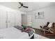 Bedroom with gray bed, wooden chair, and white closet doors at 2364 W Emelita Ave, Mesa, AZ 85202