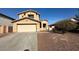 Two-story house with attached garage and desert landscaping at 25724 W St James Ave, Buckeye, AZ 85326