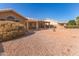 Landscaped backyard with gravel, plants, and a patio area at 26219 S Flame Tree Dr, Sun Lakes, AZ 85248