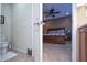 Open bathroom with toilet and view into bedroom at 27292 W Ross Ave, Buckeye, AZ 85396