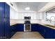 Kitchen with blue cabinets, wood floors, and butcher block counters at 2832 E Laurel St, Mesa, AZ 85213