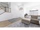 Living room with L-shaped sofa, stairs, and wood floors at 2832 E Laurel St, Mesa, AZ 85213