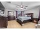 Spacious bedroom with a large bed, dresser, and ceiling fan at 30276 W Crittenden Ln, Buckeye, AZ 85396