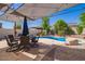Relaxing pool area with patio furniture and shade at 30276 W Crittenden Ln, Buckeye, AZ 85396