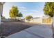 Large backyard with gravel, a tree, and a gate at 620 E Auburn Dr, Tempe, AZ 85283